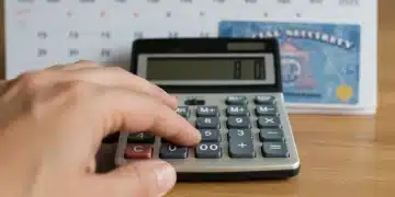 Hand calculating Social Security benefits for 2025 COLA adjustment